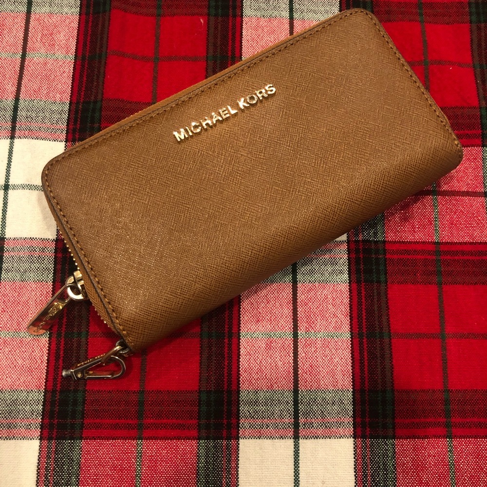 Women’s brown Michael Kors wristlet / wallet.